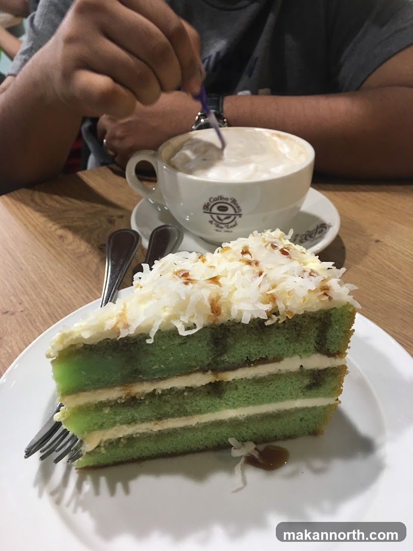 Slice of green cake with coffee
