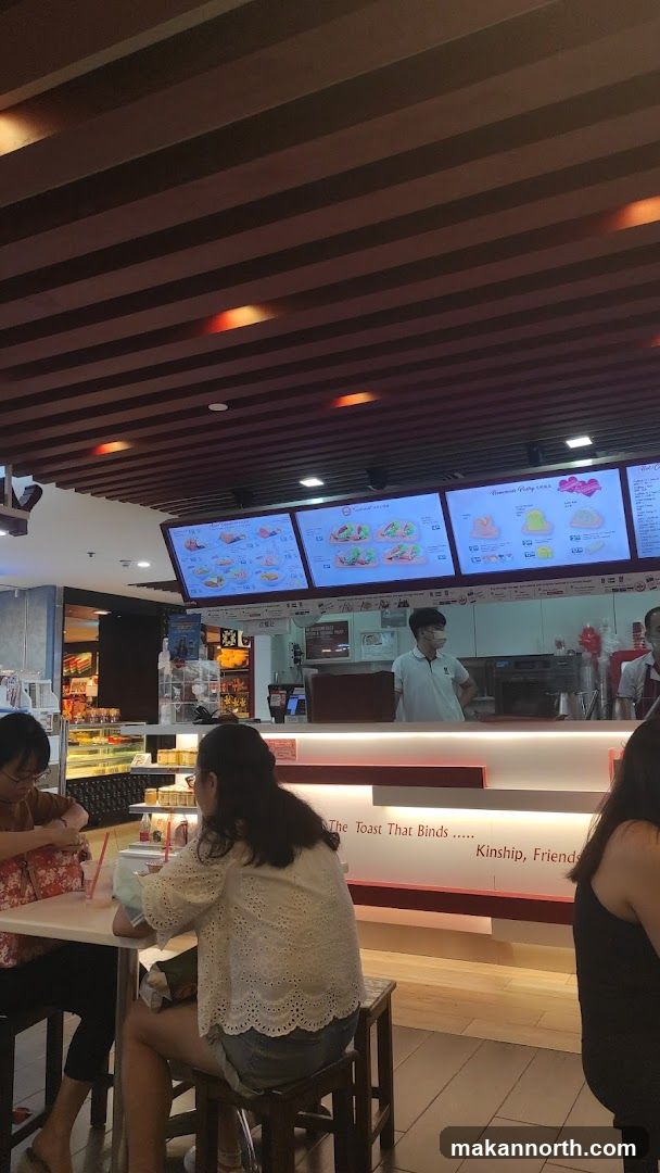Interior of a cafe with menu boards and customers
