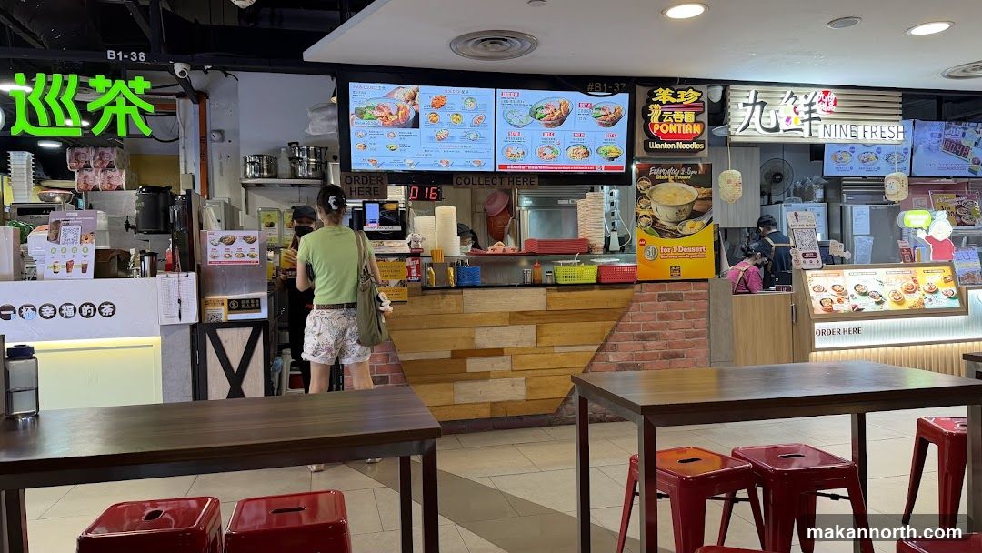 Food court stall with digital menus and seating
