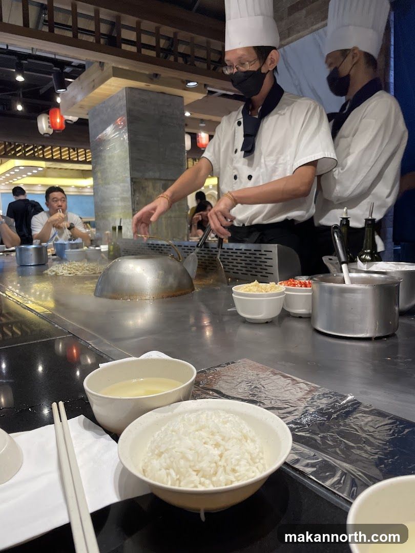 Teppanyaki chefs preparing food