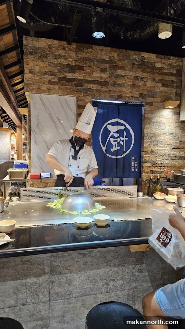 Chef cooking at a teppanyaki grill