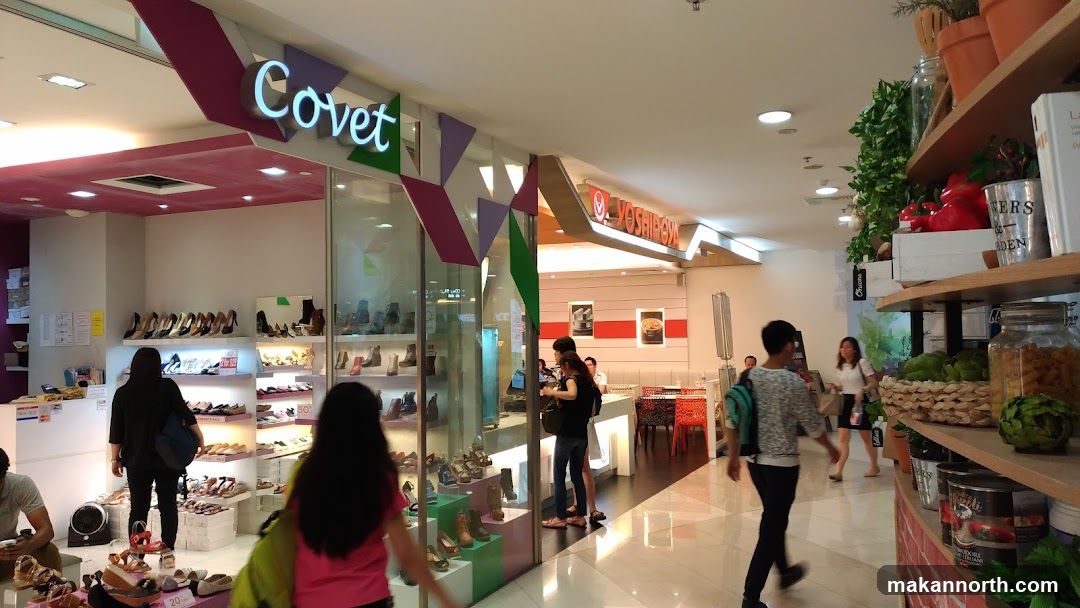 Interior of a shopping mall with shoe store and restaurant