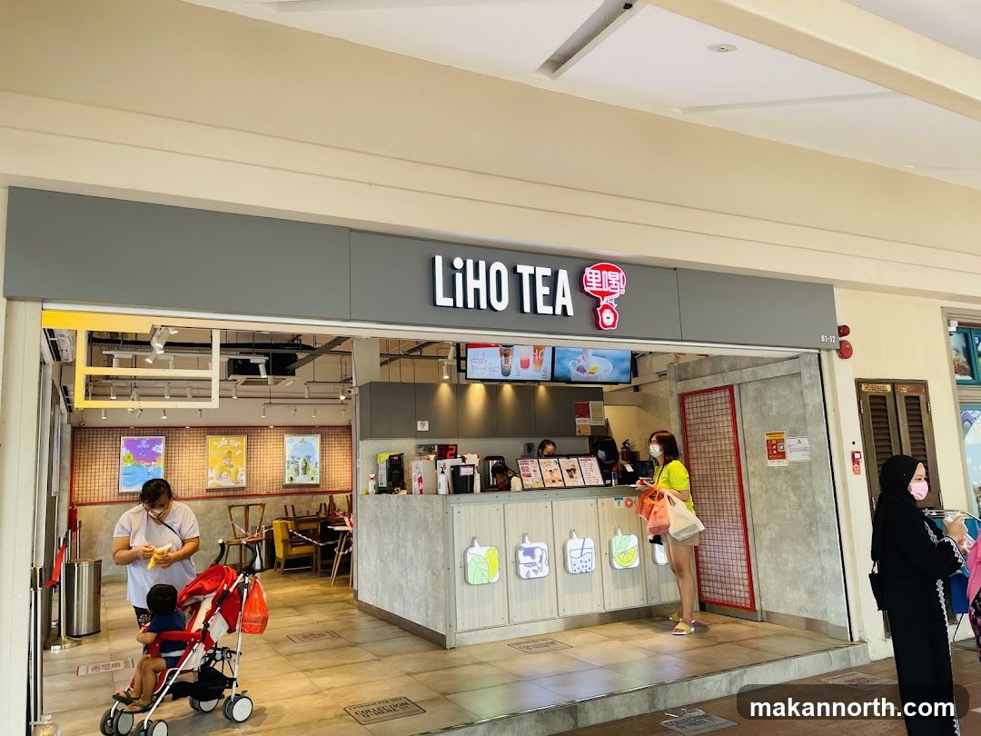 A LiHo Tea store with its prominent signage above the entrance. Inside, staff are visible behind the counter, and customers are browsing. The interior features posters and displays of drinks.
