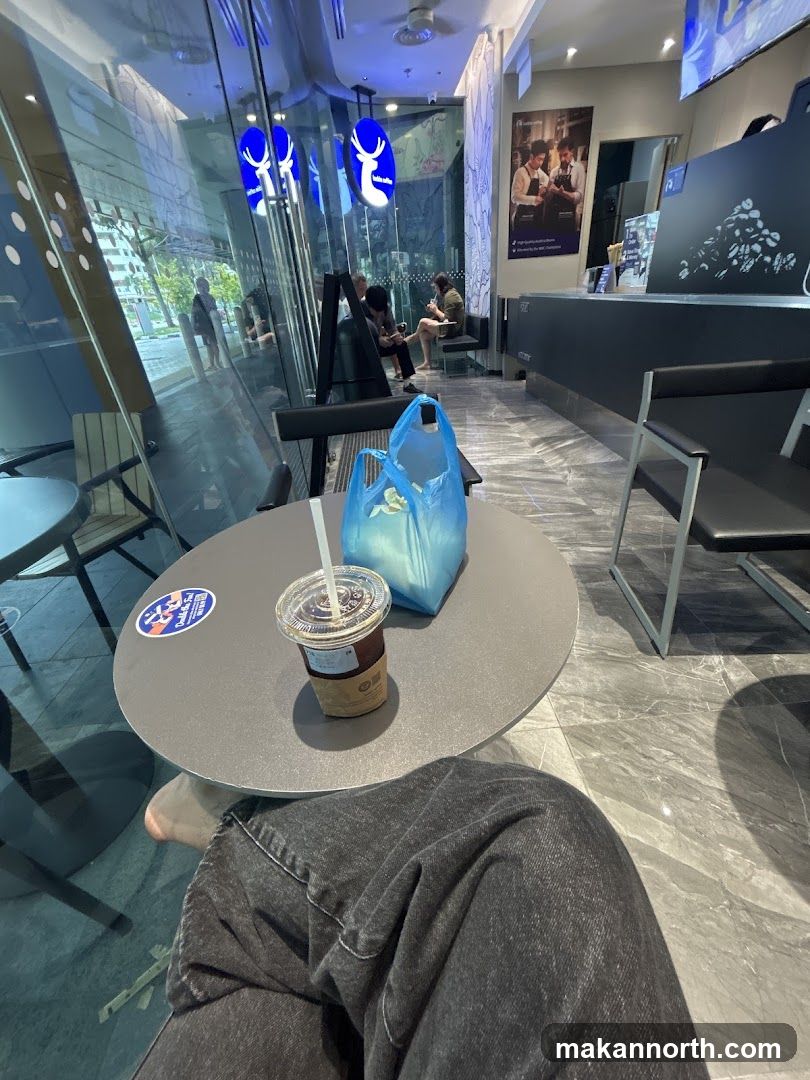 Interior of a cafe with seating and a drink
