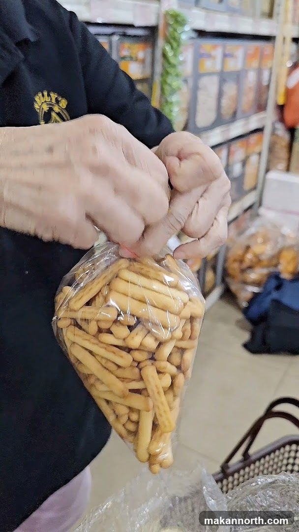 Person holding a bag of breadsticks