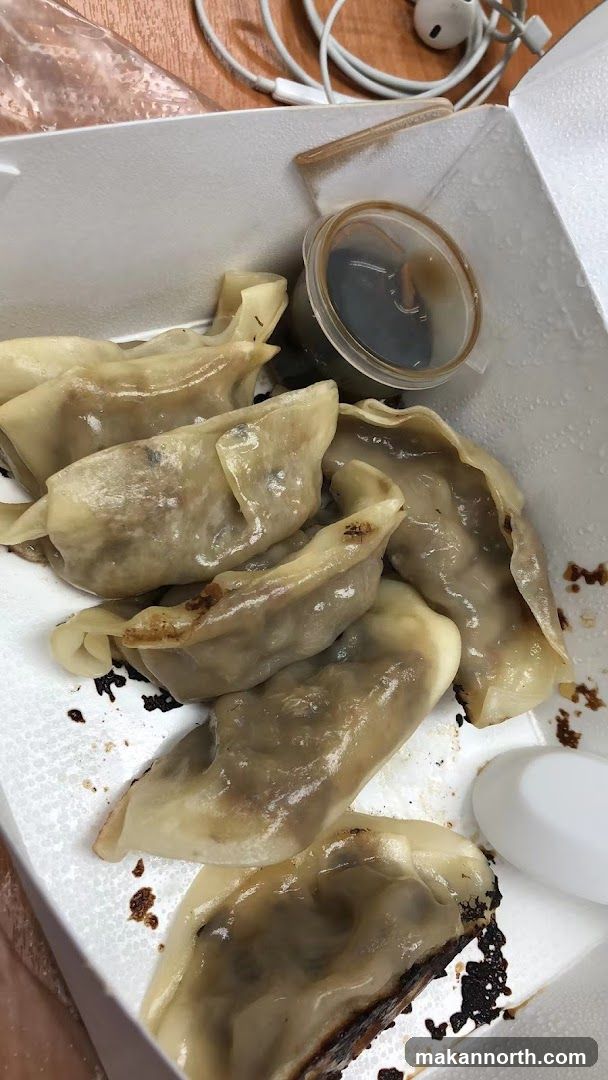 Pan-fried dumplings with dipping sauce