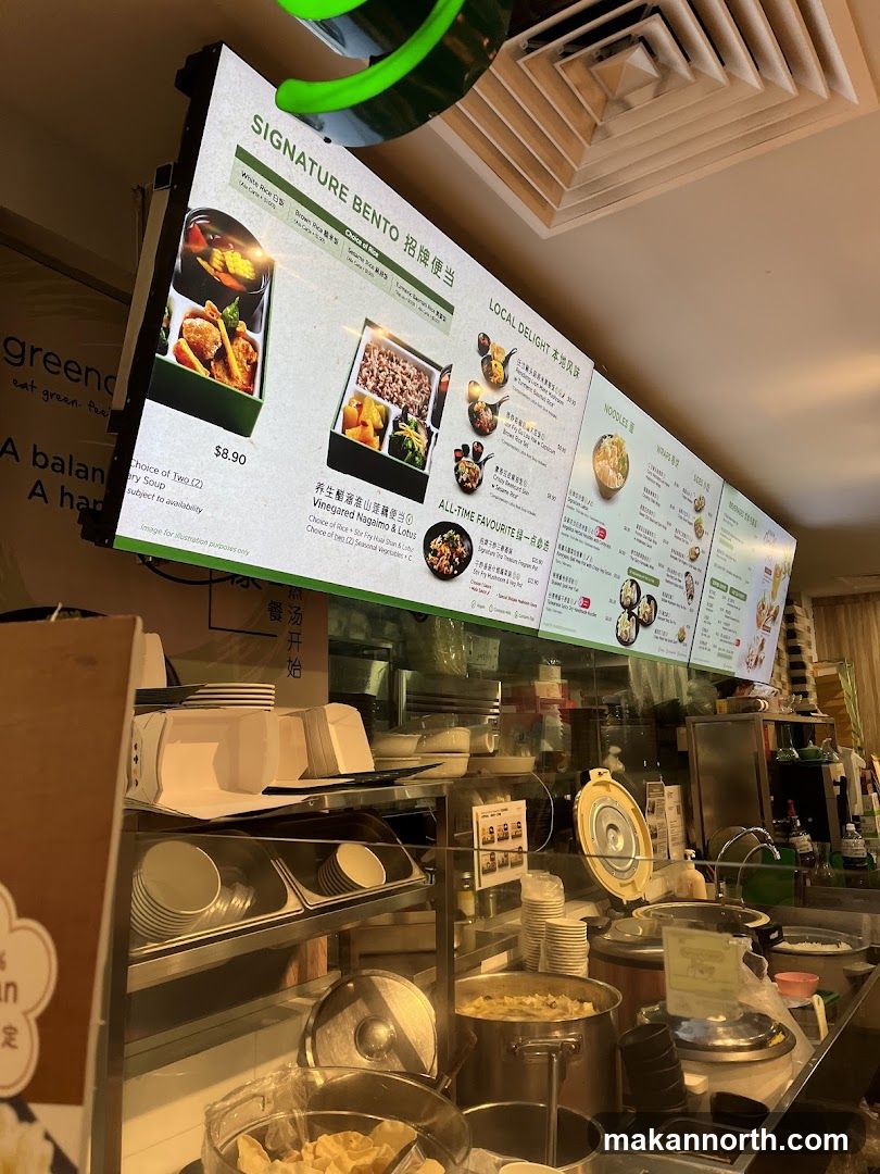 A menu board displaying various bento boxes, local delights, noodles, and wraps.
