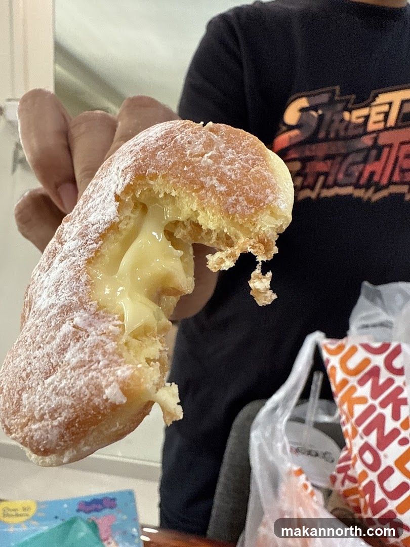 Cream-filled donut with powdered sugar