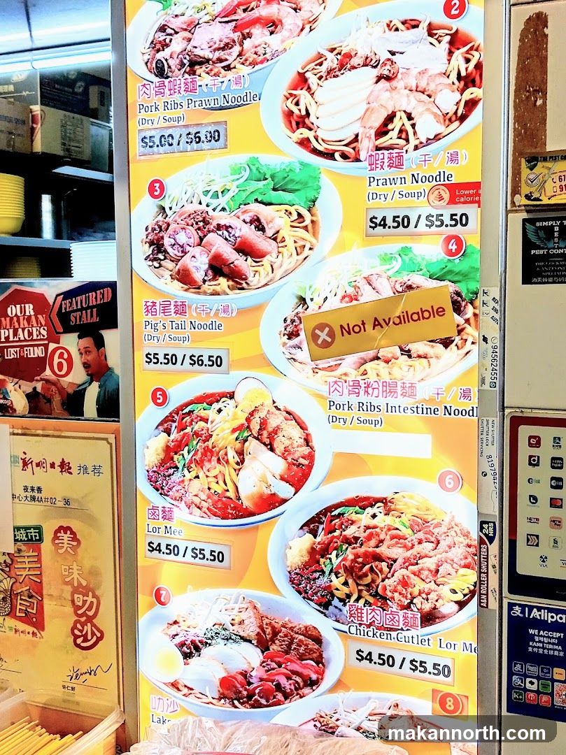 A menu board displaying various noodle dishes with prices.