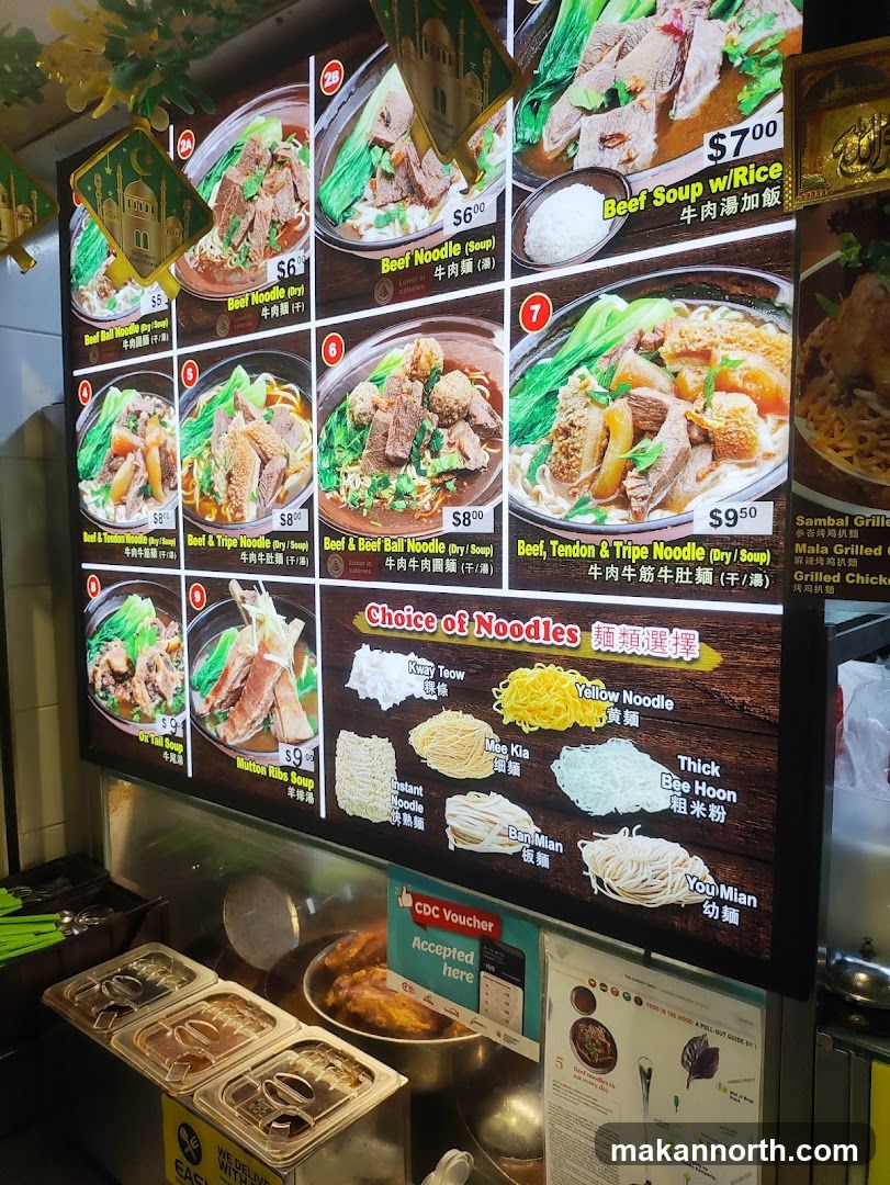 A digital menu board displaying various beef noodle dishes and noodle choices.