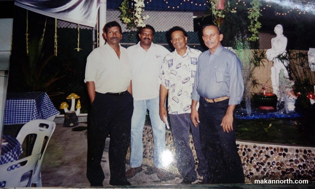 Four men posing for a photo