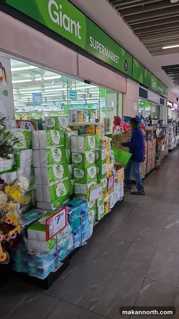 Supermarket aisle with toilet paper and other goods