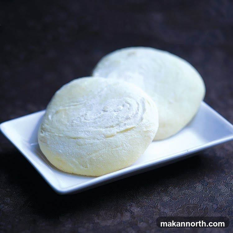 Two white pastries on a plate