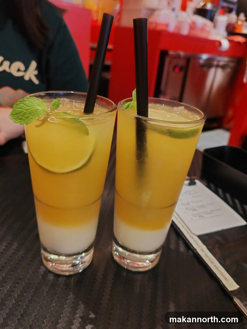 Two layered drinks with straws