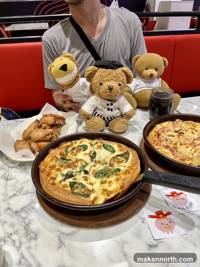Teddy bears and pizza at a restaurant