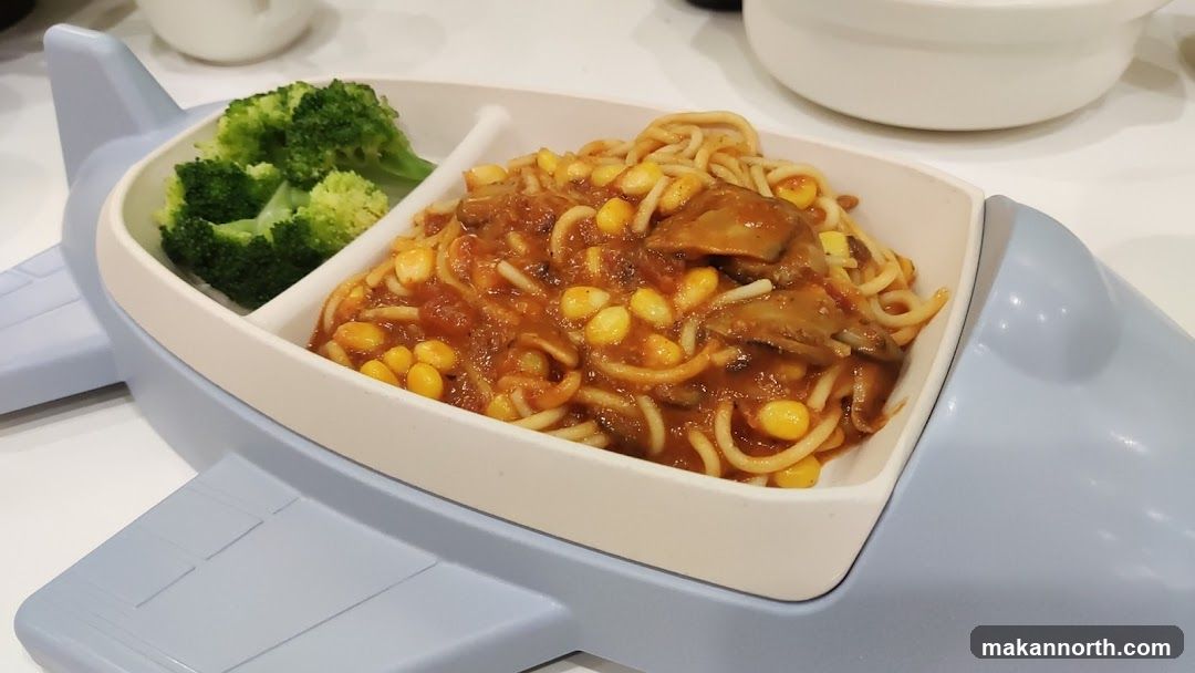 Airplane-shaped plate with spaghetti and broccoli