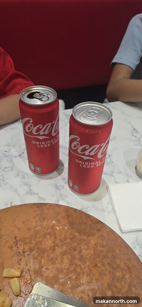 Coca-Cola Cans on Table