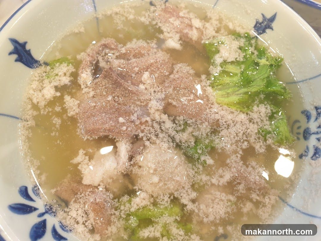 Bowl of Soup with Meat and Greens
