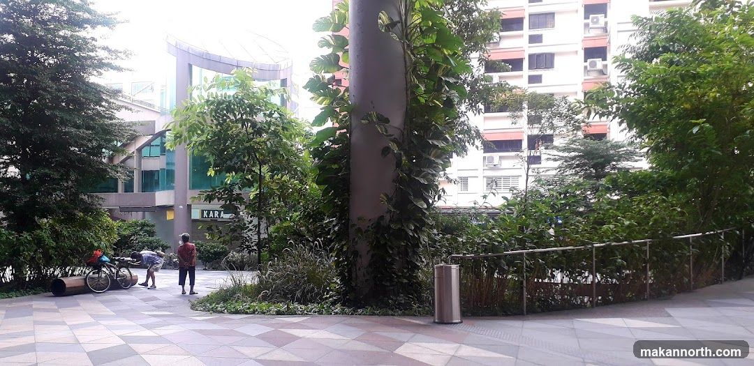 Outdoor walkway with greenery and buildings