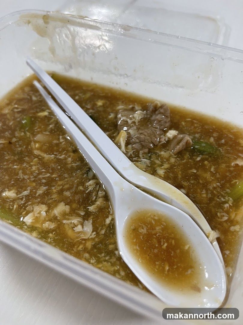 Takeout Container with Food and Spoons