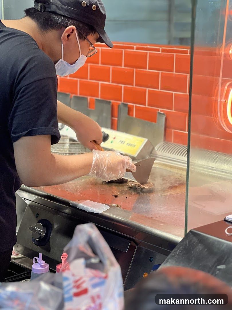 Burger being cooked on a grill