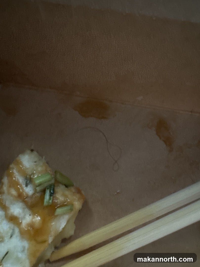 Food in a container with chopsticks