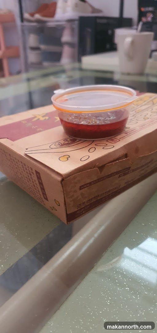 Spicy Sauce Container on Takeout Box