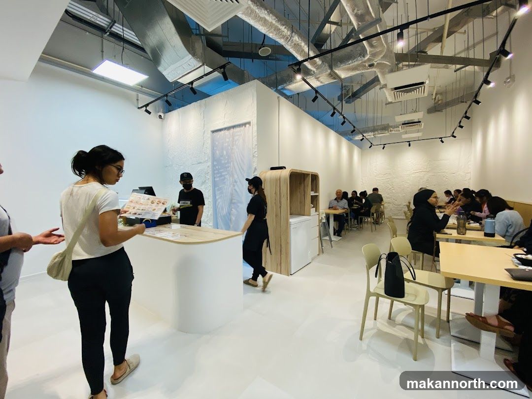 Customers ordering at a counter in a modern cafe