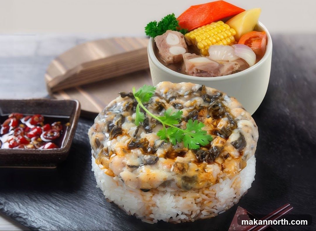 A close-up shot of a dish featuring a mound of white rice topped with a savory mixture of minced meat and vegetables, garnished with fresh cilantro. To the side, a small bowl contains a chili oil sauce. In the background, a white bowl holds a hearty soup with pork ribs, corn, carrots, tomatoes, and onions. A wooden lid is partially visible behind the soup bowl.