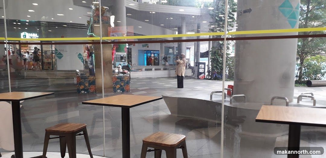 Indoor seating area with a view of a mall interior
