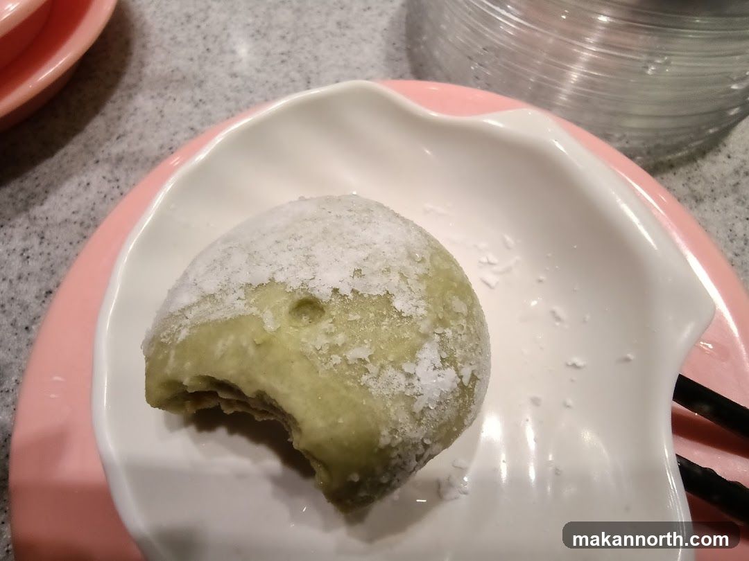 Green mochi with a bite taken out