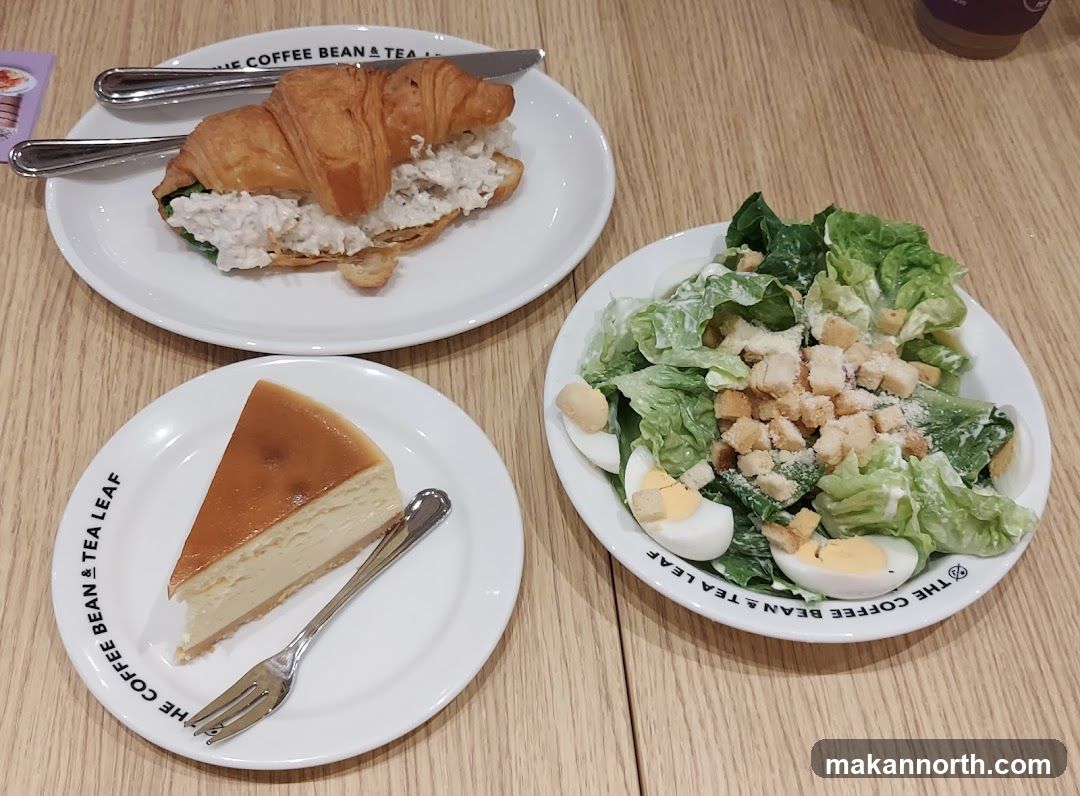 Croissant sandwich, cheesecake, and salad
