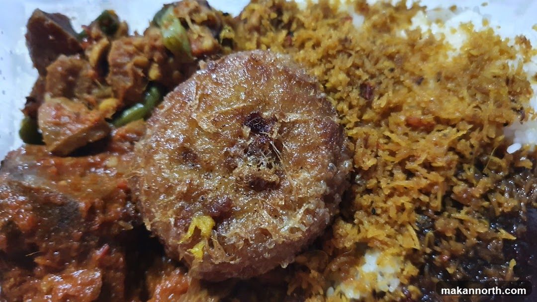 Close-up of a meal with rice and various side dishes.