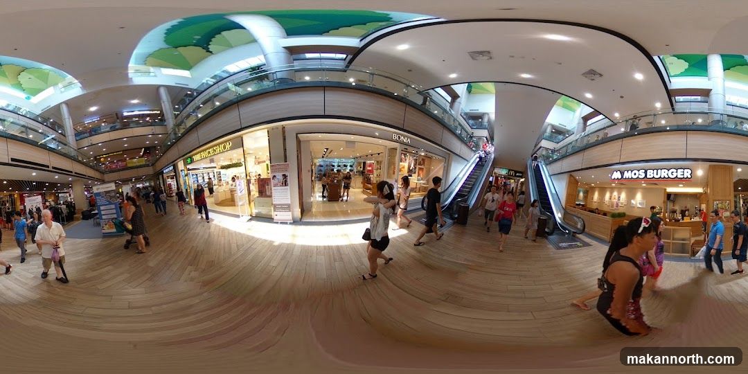 Shopping mall interior with escalators and shops