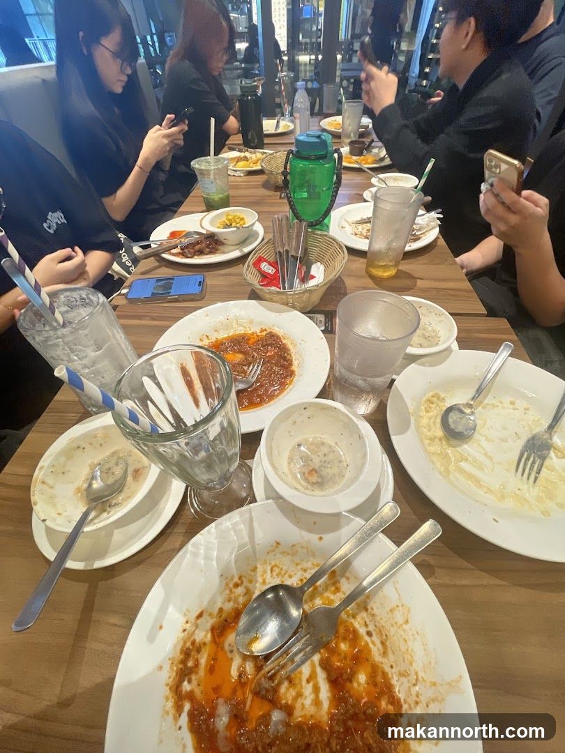 Diners at a table with partially eaten meals