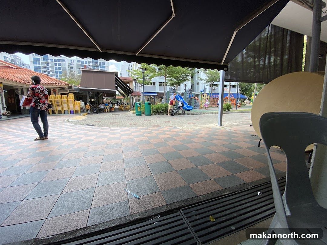Outdoor seating area with playground in background