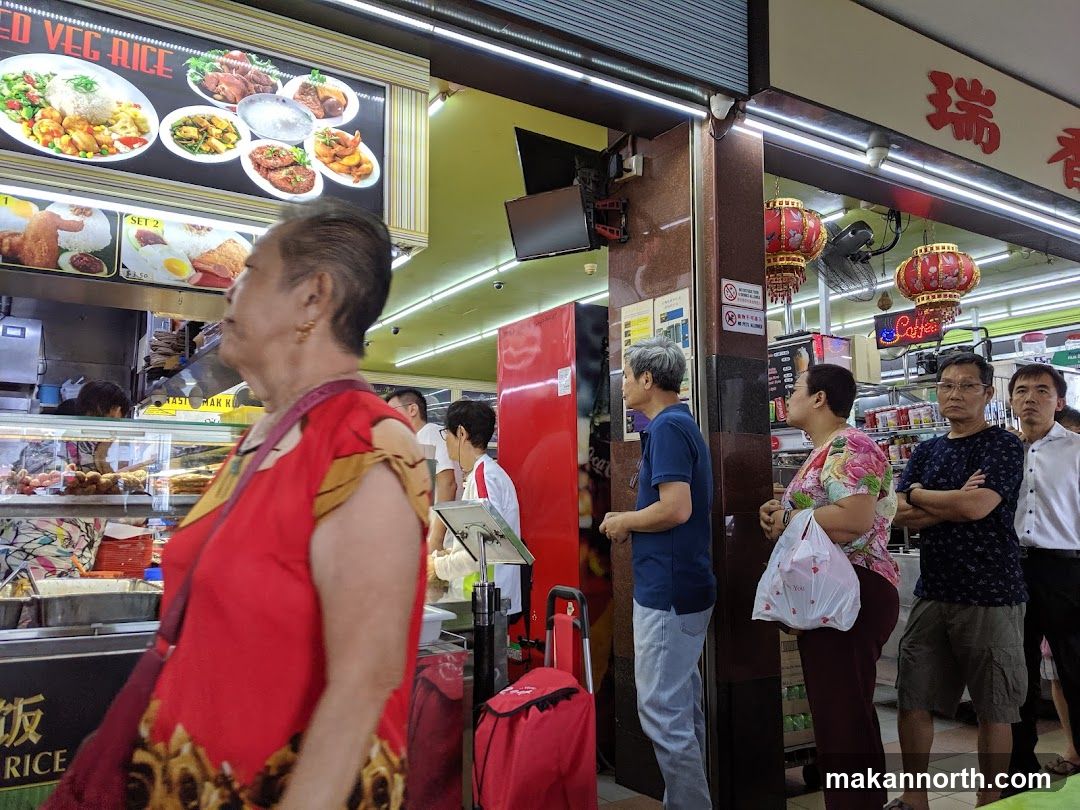 People queuing at a food stall