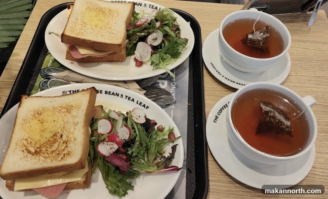 Two sandwiches and two cups of tea
