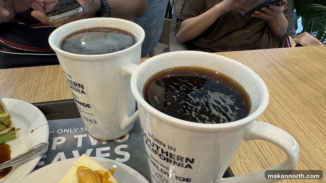Two Mugs of Coffee and Desserts