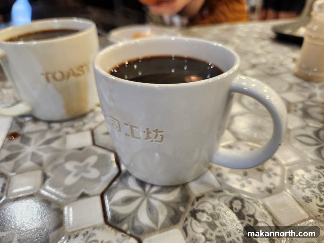 Two cups of coffee on a patterned table