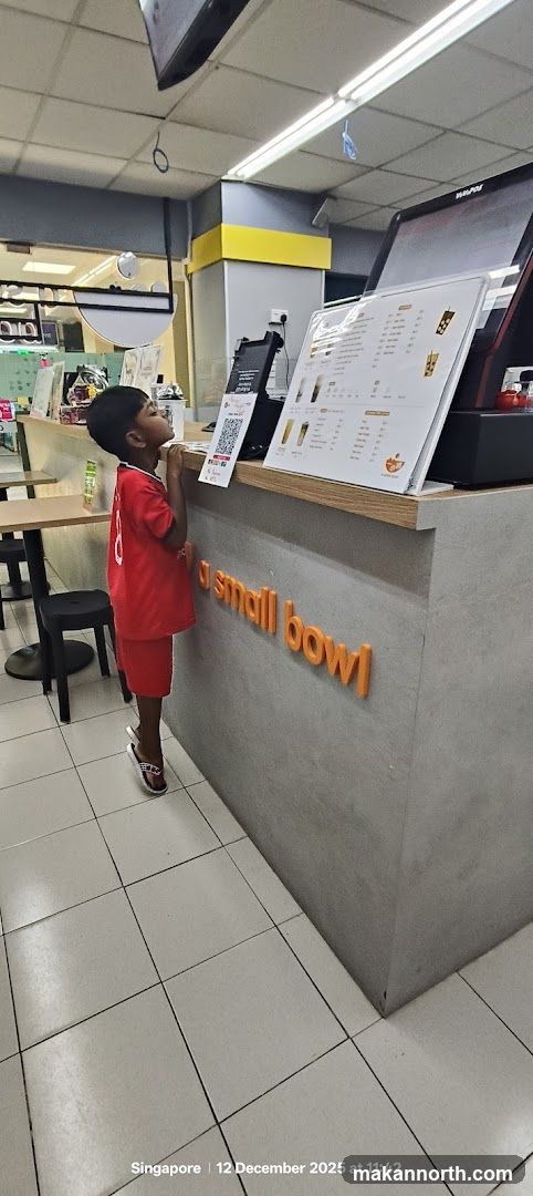 Boy looking at menu at a food stall