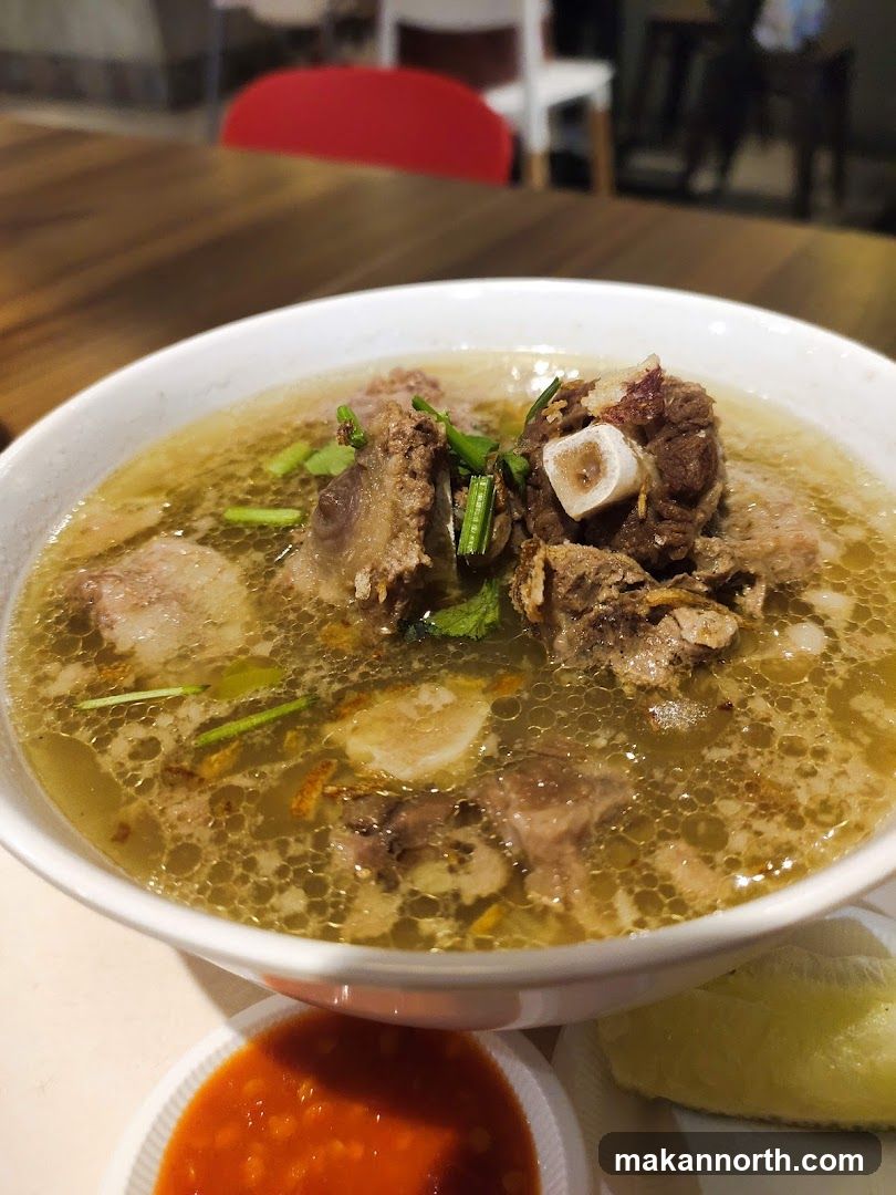 Bowl of Soup with Meat and Chili Sauce