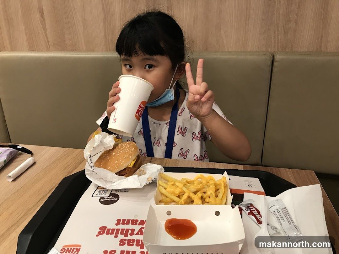 Girl drinking from a Burger King cup