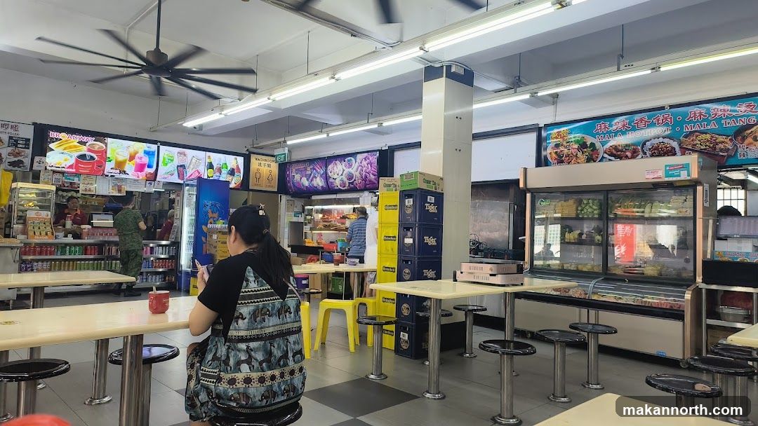 Food court interior with dining tables and food stalls