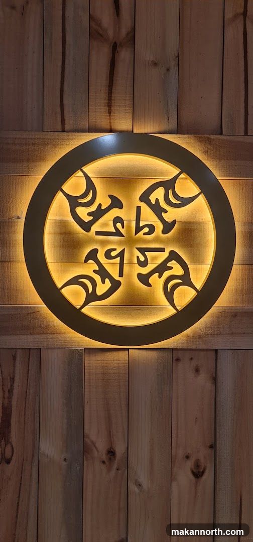 Illuminated Circular Emblem on Wood Paneling