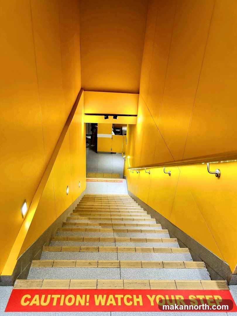 Yellow Stairwell with Caution Signs