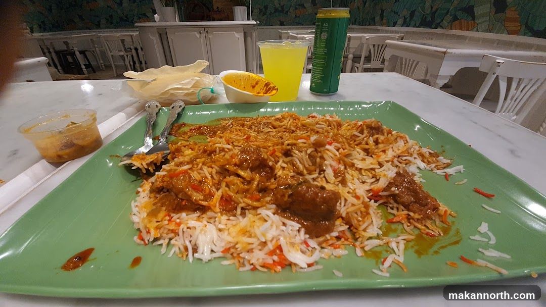 Biryani with side dishes and drink