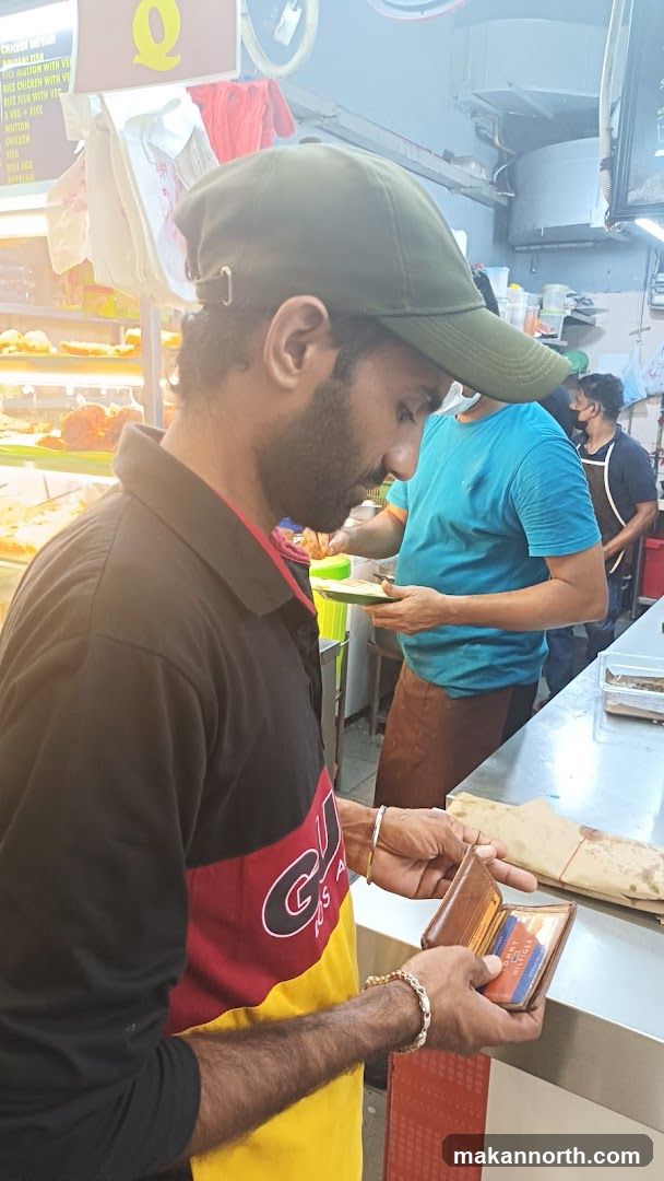 Man Paying at Food Stall