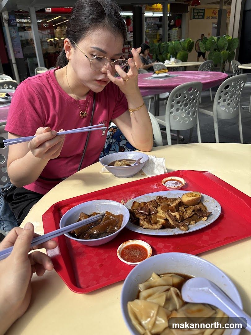Woman Eating at Outdoor Food Stall