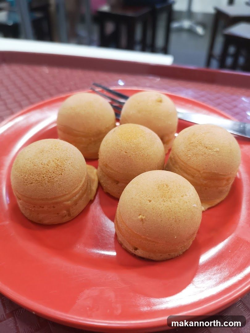 Six round pastries on a red plate